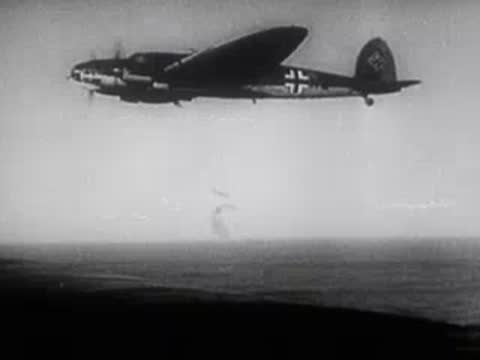 military bomber aircraft flying above the sea during wartime
