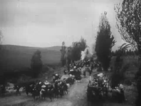 military convoy on a road and combat aircraft flying in the clouds