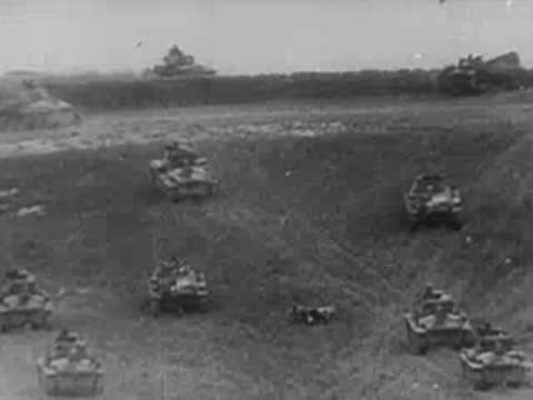 Tank tracks moving and multiple small tanks in a terrain depression, World War II