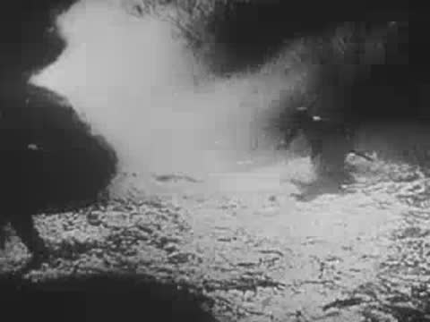Soldiers moving through smoke and fog across a battlefield, World War II