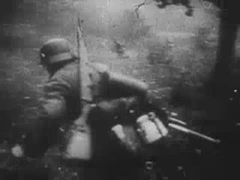Combat action in a trench with soldiers moving under fire.