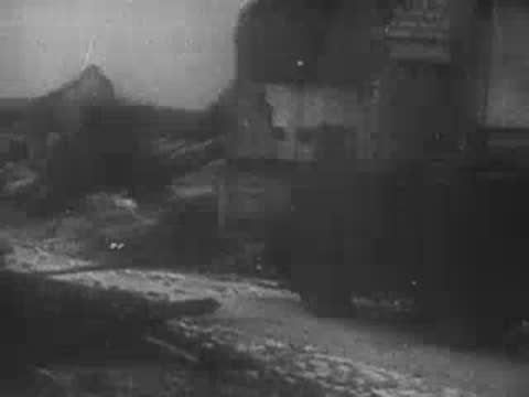 Explosion occurring near a ruined building during combat.