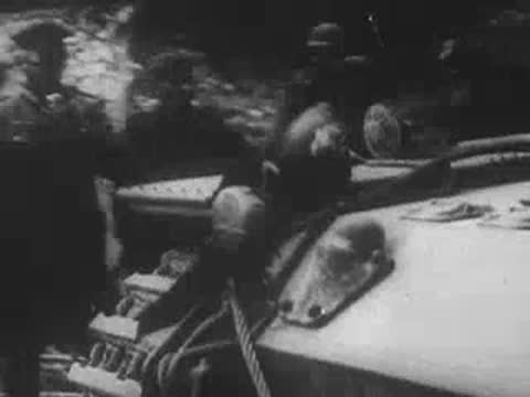 View from inside a moving armored vehicle advancing forward.