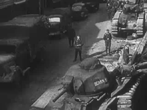 Destroyed French tanks and military equipment on a city street.