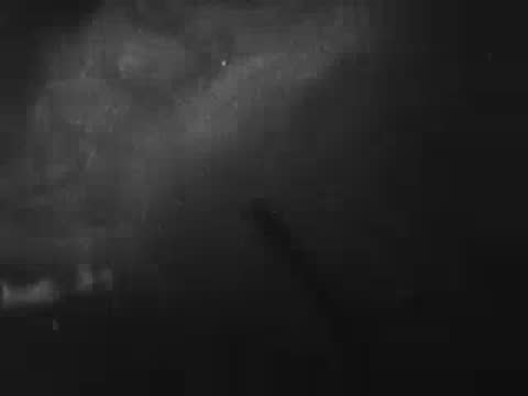 Dark cloudy sky with a bright explosion or flash of light.