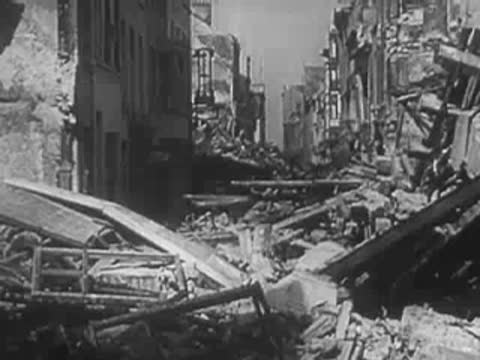 Severely destroyed urban street blocked by piles of rubble and wreckage, WWII