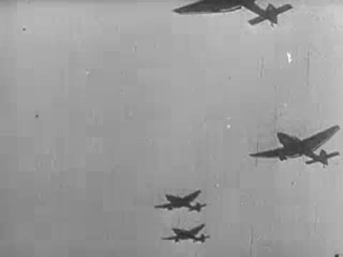 Formation of military transport aircraft flying through the sky, WWII