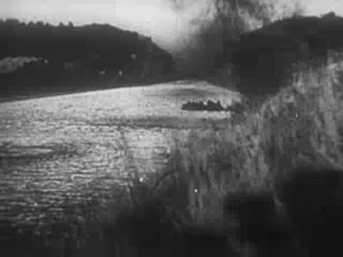 Soldiers cross a river in a boat, archive footage