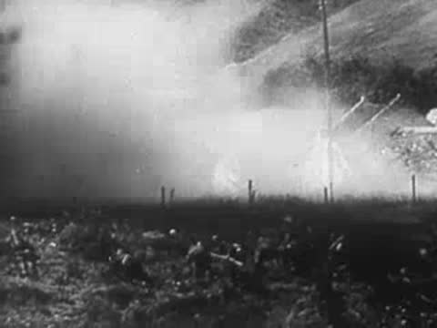 Heavy smoke and artillery fire in a field, archive footage