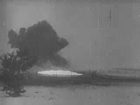 Soldiers advance and heavy explosion occurs nearby, archive footage