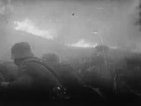 Soldiers in smoke-filled trench during combat, archive footage