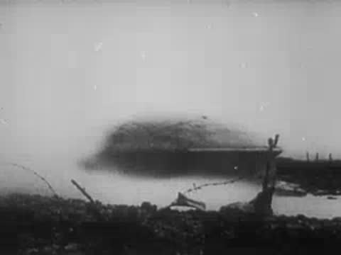 Smoke surrounds a concrete pillbox fortification, archive footage