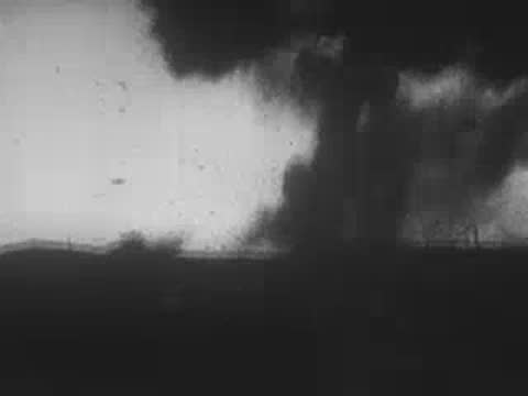 Explosions and a soldier running with a machine gun, archive footage
