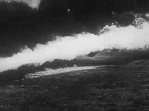 Dense smoke cloud rolling across open ground, archive footage