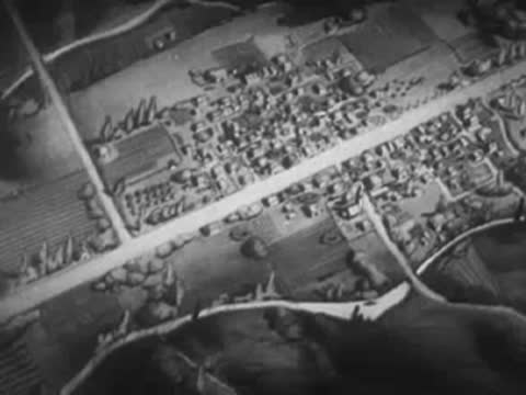 Aerial animation of airplanes flying over a mapped town with explosions.