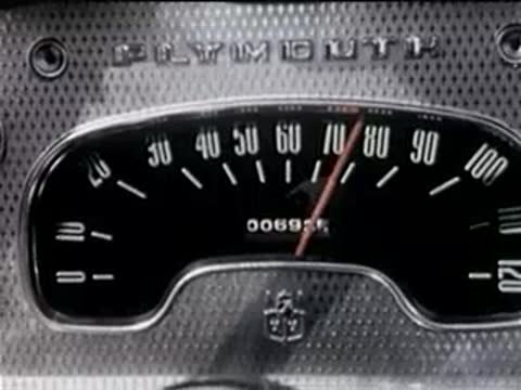 Dashboard speedometer inside a car showing speed increasing as the vehicle moves.