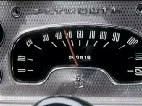 Car speedometer showing a steady speed while driving on a road.