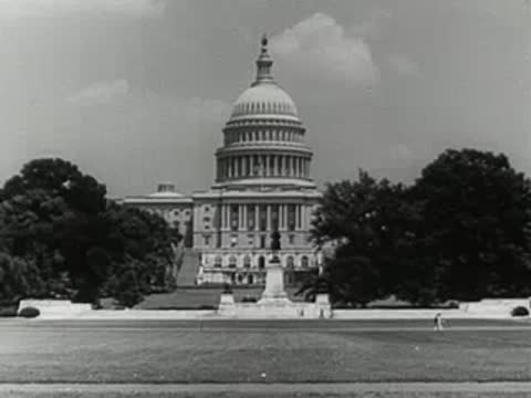 The United States Capitol building with trees and lawn in Washington, D.C.