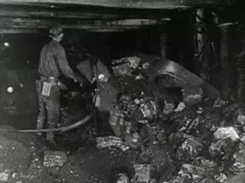Cargo ship docked; underground mining worker with equipment; rock pile.
