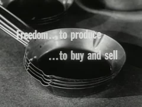 stack of metal frying pans on hardware store counter with economic text overlay
