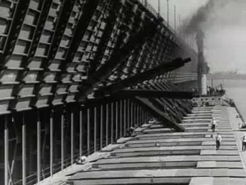 ore loading dock with conveyor chutes over cargo ship, 1950s industrial