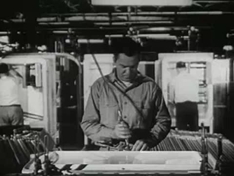 A factory worker operating machinery in an industrial processing plant