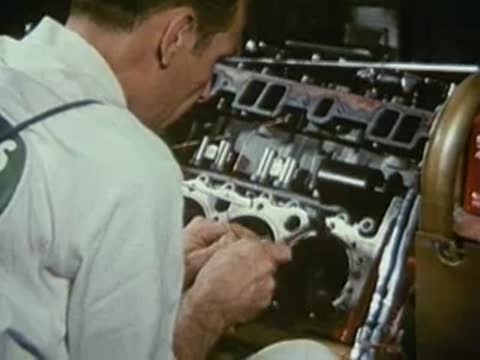 Mechanic working on the internal parts of a large engine.
