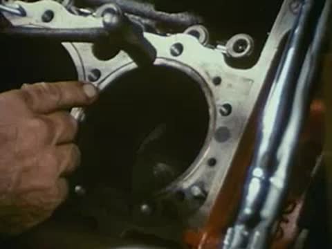 Close-up of a mechanic inspecting engine cylinders.