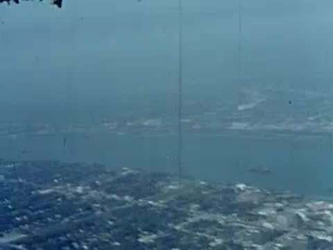 Aerial view from a small plane descending toward a flat area.