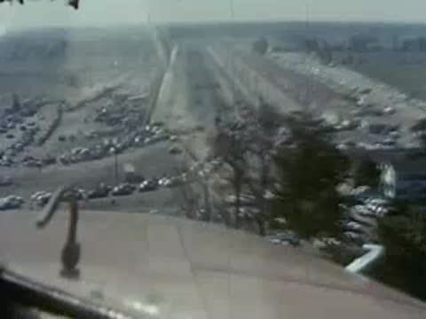 Aerial view of parked cars and a long strip of land.