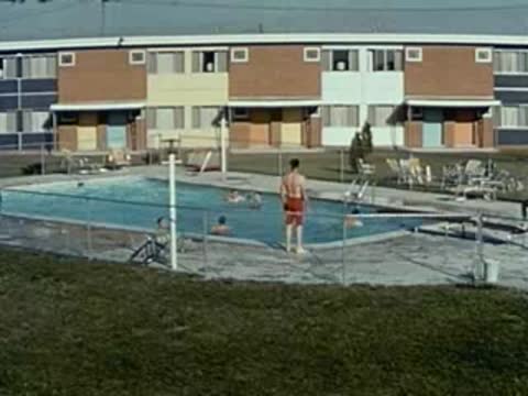 motel swimming pool with people, 1950s architecture