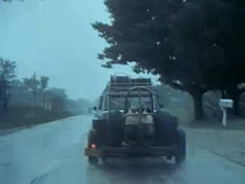car towing trailer on wet road, rainy day travel
