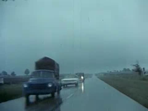 cars driving on wet highway in rain, vintage vehicles