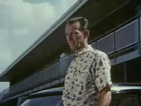 man talking outdoors in front of building, 1950s style
