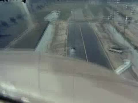Low aerial view flying directly over the drag strip.