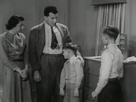Family gathered in room watching chemistry experiments.