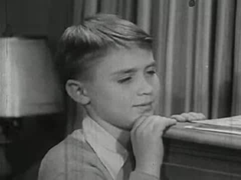 Close-up of young boy watching chemistry experiments with interest.