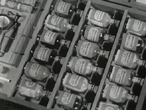 Close-up of chemistry set vials and bottles in wooden box