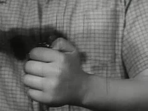 Close-up of hands opening glass vial, breaking glass top