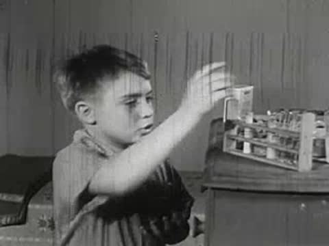 Boy looking at stained hands and reacting in room