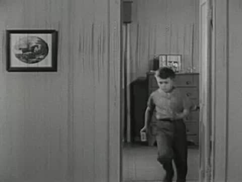 Boy running out of bedroom into hallway, vintage interior