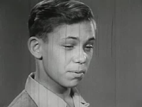 Close-up of an older boy working with chemistry equipment.