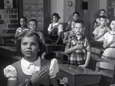 A man speaking at a desk, followed by a classroom of children saluting an American flag.