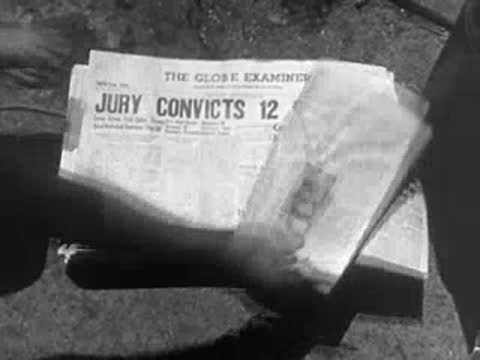 A stack of newspapers on the ground with a headline reading JURY CONVICTS 12 COMMIES.