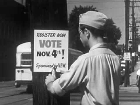 Person pasting "Vote Nov. 4th!" poster on utility pole, 1950s street scene.
