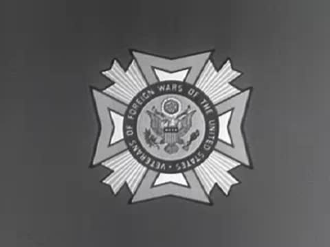 Veterans of Foreign Wars emblem shrinking on dark background, 1950s.