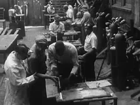 Workers in a manufacturing or assembly plant performing various tasks.