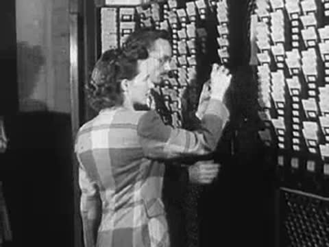 People standing in front of information boards filled with slips of paper