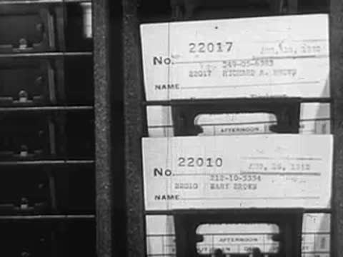 Close-up of noticeboard with pinned cards displaying names and numbers
