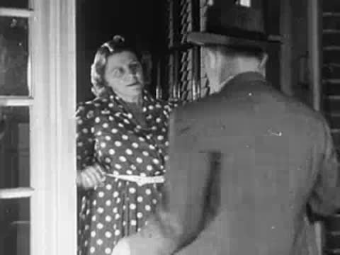 Man and woman standing in a doorway having a conversation